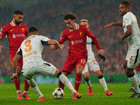 Liverpool's Curtis Jones looks for a way through Piero Hincapie and Jonathan Tah of Bayer Leverkusen during the UEFA Champions League 2024/2...