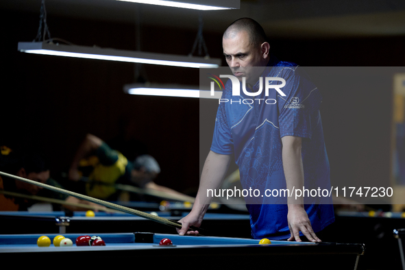 A participant from the Scotland Pool Association men's team reflects during one of the events at the inaugural IBF World Blackball Champions...