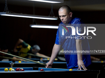 A participant from the Scotland Pool Association men's team reflects during one of the events at the inaugural IBF World Blackball Champions...