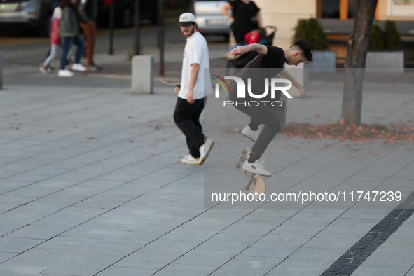 People skateboard on the square in Krakow, Poland, on October 27, 2024. 