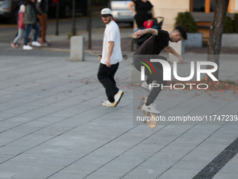 People skateboard on the square in Krakow, Poland, on October 27, 2024. (