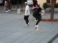 People skateboard on the square in Krakow, Poland, on October 27, 2024. (