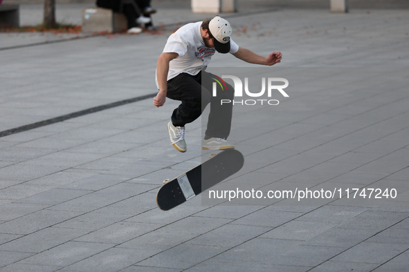 People skateboard on the square in Krakow, Poland, on October 27, 2024. 