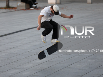 People skateboard on the square in Krakow, Poland, on October 27, 2024. (