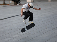 People skateboard on the square in Krakow, Poland, on October 27, 2024. (