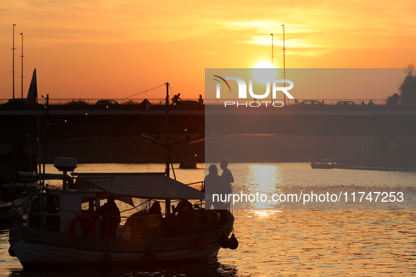 A boat floats on the Vistula River at sunset in Krakow, Poland, on October 27, 2024. 