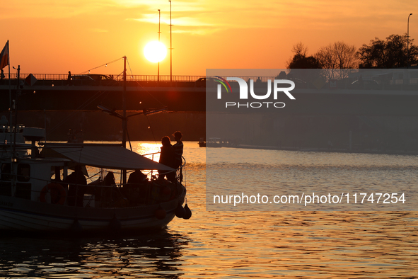 A boat floats on the Vistula River at sunset in Krakow, Poland, on October 27, 2024. 