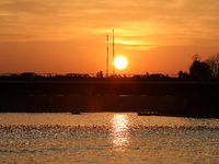 A bridge with cars is on the Vistula River at sunset in Krakow, Poland, on October 27, 2024. (