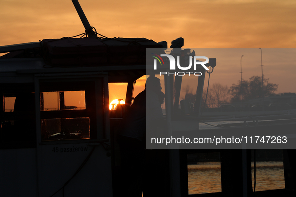 A boat floats on the Vistula River at sunset in Krakow, Poland, on October 27, 2024. 