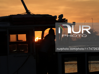 A boat floats on the Vistula River at sunset in Krakow, Poland, on October 27, 2024. (