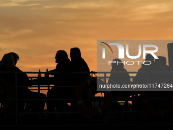 A boat floats on the Vistula River at sunset in Krakow, Poland, on October 27, 2024. (