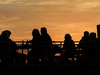 A boat floats on the Vistula River at sunset in Krakow, Poland, on October 27, 2024. (