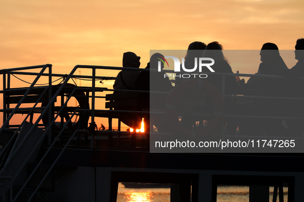 A boat floats on the Vistula River at sunset in Krakow, Poland, on October 27, 2024. 