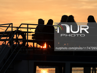 A boat floats on the Vistula River at sunset in Krakow, Poland, on October 27, 2024. (