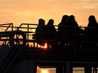 A boat floats on the Vistula River at sunset in Krakow, Poland, on October 27, 2024. (