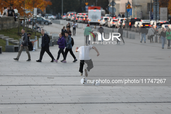 People skateboard on the square in Krakow, Poland, on October 27, 2024. 