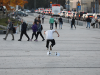 People skateboard on the square in Krakow, Poland, on October 27, 2024. (