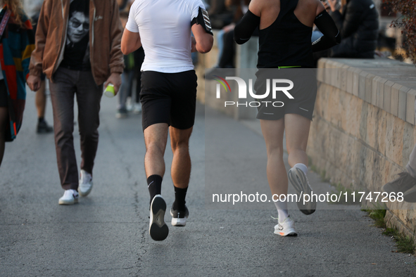 People run on the boulevards along the Vistula River in Krakow, Poland, on October 27, 2024. 