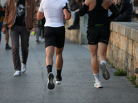 People run on the boulevards along the Vistula River in Krakow, Poland, on October 27, 2024. (