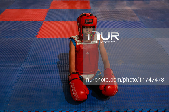 Moiz Masoodi, a wushu athlete, looks on before the start of his fight during a championship in Baramulla, Jammu and Kashmir, India, on Novem...