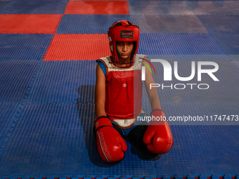 Moiz Masoodi, a wushu athlete, looks on before the start of his fight during a championship in Baramulla, Jammu and Kashmir, India, on Novem...