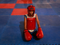 Moiz Masoodi, a wushu athlete, looks on before the start of his fight during a championship in Baramulla, Jammu and Kashmir, India, on Novem...