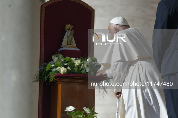 Pope Francis places a white rose on the statue of the Madonna of Valencia before the weekly general audience at St. Peter's Square in The Va...