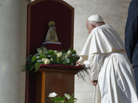 Pope Francis places a white rose on the statue of the Madonna of Valencia before the weekly general audience at St. Peter's Square in The Va...