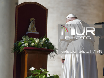 Pope Francis places a white rose on the statue of the Madonna of Valencia before the weekly general audience at St. Peter's Square in The Va...