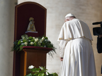 Pope Francis places a white rose on the statue of the Madonna of Valencia before the weekly general audience at St. Peter's Square in The Va...