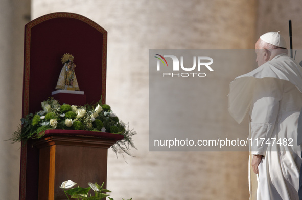 Pope Francis places a white rose on the statue of the Madonna of Valencia before the weekly general audience at St. Peter's Square in The Va...