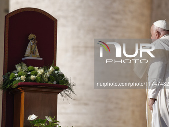 Pope Francis places a white rose on the statue of the Madonna of Valencia before the weekly general audience at St. Peter's Square in The Va...