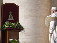 Pope Francis places a white rose on the statue of the Madonna of Valencia before the weekly general audience at St. Peter's Square in The Va...