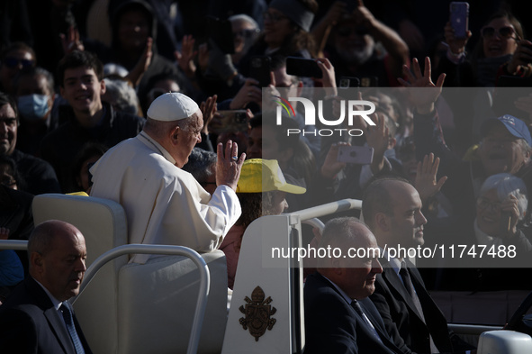 Pope Francis waves to pilgrims after attending the weekly general audience at St. Peter's Square in The Vatican on November 6, 2024. 