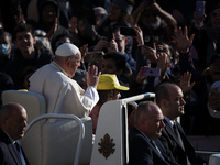 Pope Francis waves to pilgrims after attending the weekly general audience at St. Peter's Square in The Vatican on November 6, 2024. (