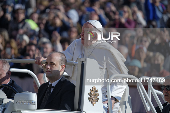 Pope Francis waves to pilgrims after attending the weekly general audience at St. Peter's Square in The Vatican on November 6, 2024. 