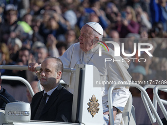 Pope Francis waves to pilgrims after attending the weekly general audience at St. Peter's Square in The Vatican on November 6, 2024. (