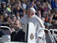 Pope Francis waves to pilgrims after attending the weekly general audience at St. Peter's Square in The Vatican on November 6, 2024. (