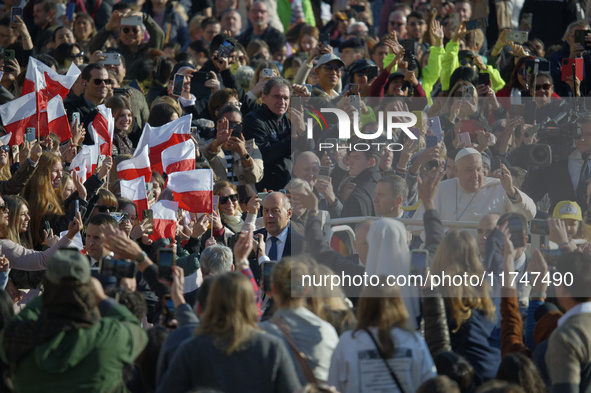 Pope Francis waves to pilgrims after attending the weekly general audience at St. Peter's Square in The Vatican on November 6, 2024. 