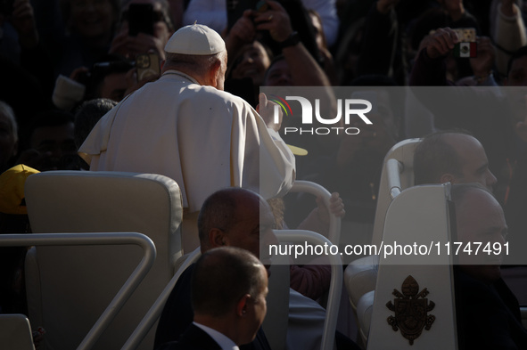 Pope Francis waves to pilgrims after attending the weekly general audience at St. Peter's Square in The Vatican on November 6, 2024. 