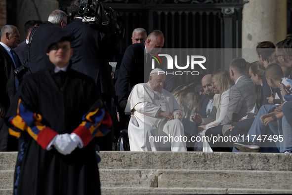 Pope Francis waves to the faithful during the weekly general audience in St. Peter's Square, at the Vatican, on November 6, 2024. 