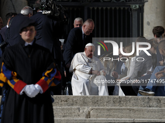 Pope Francis waves to the faithful during the weekly general audience in St. Peter's Square, at the Vatican, on November 6, 2024. (