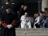 Pope Francis waves to the faithful during the weekly general audience in St. Peter's Square, at the Vatican, on November 6, 2024. (