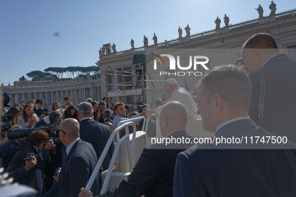 Pope Francis greets and talks with a group of students at the end of his general weekly audience in Vatican City, on November 6, 2024. 