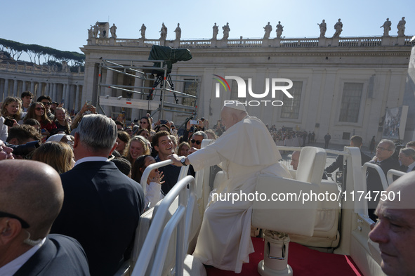 Pope Francis greets and talks with a group of students at the end of his general weekly audience in Vatican City, on November 6, 2024. 