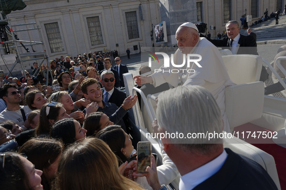 Pope Francis greets and talks with a group of students at the end of his general weekly audience in Vatican City, on November 6, 2024. 