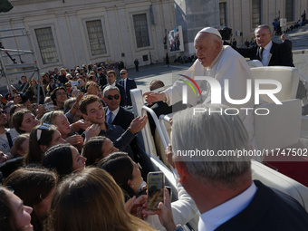 Pope Francis greets and talks with a group of students at the end of his general weekly audience in Vatican City, on November 6, 2024. (