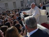 Pope Francis greets and talks with a group of students at the end of his general weekly audience in Vatican City, on November 6, 2024. (