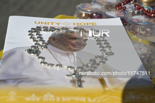 The photo shows a book with the image of Pope Francis and a Rosary during the general audience of Pope Francis in St. Peter's Square, at the...