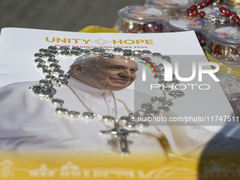 The photo shows a book with the image of Pope Francis and a Rosary during the general audience of Pope Francis in St. Peter's Square, at the...